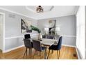 Elegant dining room with modern lighting, stylish decor, and hardwood floors at 9275 Eastwind Dr, Indianapolis, IN 46256