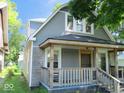 Stylish home showcasing a covered front porch, updated siding, and a welcoming entrance at 1138 W 33Rd St, Indianapolis, IN 46208