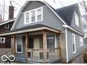 Gray house with wooden porch and snowy yard at 1138 W 33Rd St, Indianapolis, IN 46208