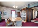 Formal dining room with fireplace, wood floors and period details at 125 W 11Th St, Anderson, IN 46016