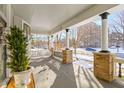 Long front porch offering views of a snow-covered street at 1471 N Delaware St, Indianapolis, IN 46202