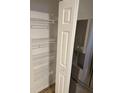 Well-lit pantry with wire shelving and stainless steel fridge at 1608 Wagner Dr, Shelbyville, IN 46176