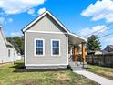 Craftsman home with gray siding, a covered porch, and walkway at 1631 Brier Pl, Indianapolis, IN 46203