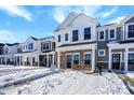 Row of townhomes in winter setting; snow on ground at 19456 Northwest Dr, Westfield, IN 46074