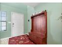 Entryway with a wooden bench, storage, and a red rug at 2359 Shoemaker Ct, Indianapolis, IN 46229