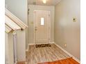 Bright entryway with light wood-look floors and a coat rack at 2925 Everbloom Pl, Indianapolis, IN 46217