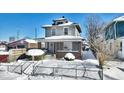Two-story house with brick front and covered porch, snow-covered yard at 2957 Winthrop Ave, Indianapolis, IN 46205