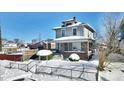 Two-story house with brick front and covered porch, snow-covered yard at 2957 Winthrop Ave, Indianapolis, IN 46205