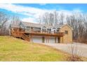 Ranch home with stone accents, expansive deck, and a three-car garage at 3264 W Roberts Rd, Trafalgar, IN 46181