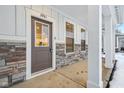 Modern front door with stone accents and a covered porch at 3921 Wren Dr, Brownsburg, IN 46112