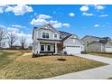 Beautiful exterior view of home with a two-car garage, landscaping, and a well-manicured lawn at 4103 Railhead Ave, Westfield, IN 46074