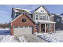 Two-story home with gray siding and brick accents, freshly fallen snow at 4223 Mardale Ln, Bargersville, IN 46106