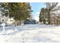 House exterior showcasing snowy yard and landscaping at 435 Belmar Ave, Indianapolis, IN 46219