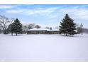 Ranch home exterior, snow covered yard at 457 S High School Rd, Indianapolis, IN 46241