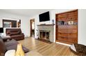 Living room with fireplace, built-in shelving, hardwood floors at 457 S High School Rd, Indianapolis, IN 46241