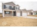 Charming two-story home featuring a brick facade, gray siding, attached two-car garage, and front porch at 6039 Granby Dr, Whitestown, IN 46075