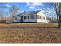 Well-kept home with a detached garage and a peaceful, grassy lawn at 6471 Homestead Dr, Indianapolis, IN 46227