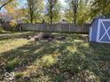 Spacious backyard with a fire pit and a shed at 709 Andrea Dr, Beech Grove, IN 46107