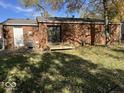 Brick home's backyard features a deck and a large grassy area at 709 Andrea Dr, Beech Grove, IN 46107