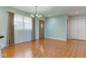 Cozy living room with wood floors, a stylish chandelier, and a large window offering plenty of natural light at 8116 E 900 N, Wilkinson, IN 46186
