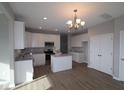 White cabinets, stainless steel appliances, and an island at 10115 Redwood Peak Ln, Indianapolis, IN 46259