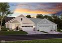 Tan and gray two-story home with a three-car garage at 16673 Cattle Hollow Ln, Noblesville, IN 46060