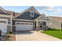 Inviting home with a two-car garage, well-maintained lawn, and stone accents on the facade at 16673 Cattle Hollow Ln, Noblesville, IN 46060