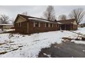 Brick ranch home with snow-covered yard and driveway at 17 Riverview Dr, Anderson, IN 46012