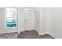 Bright foyer with white door and vinyl plank flooring at 1836 Blenker Dr, Carmel, IN 46032