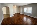 Hardwood floor dining room with arched entry to kitchen at 2116 N Rosewood Ave, Muncie, IN 47304