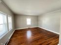 Spacious living room featuring hardwood floors and neutral walls at 2116 N Rosewood Ave, Muncie, IN 47304
