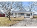 Charming ranch house with gray siding, stone accents, and a spacious driveway at 2521 Cicero Rd, Noblesville, IN 46060