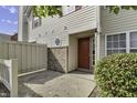 Red door entry to tan townhouse with brick accents at 4652 Kimmeridge Ln, Indianapolis, IN 46254