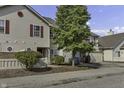 Tan two-story townhouse with red door and landscaping at 4652 Kimmeridge Ln, Indianapolis, IN 46254