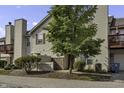 Tan two-story townhouse with red door and landscaping at 4652 Kimmeridge Ln, Indianapolis, IN 46254