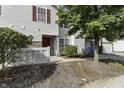 Tan two-story townhouse with red door and landscaping at 4652 Kimmeridge Ln, Indianapolis, IN 46254