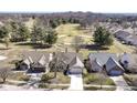 An aerial view showcases a beautiful residential neighborhood next to a lush golf course at 4842 Ashbrook Dr, Noblesville, IN 46062