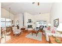 Bright living room boasts high ceilings, hardwood floors, a cozy fireplace, and lots of natural light at 4842 Ashbrook Dr, Noblesville, IN 46062