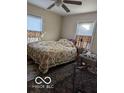 Bright bedroom with floral bedding and ceiling fan at 5708 N Keystone Ave, Indianapolis, IN 46220