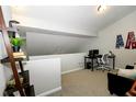 Cozy loft area with neutral walls, a functional desk setup and a comfortable seating area perfect for relaxation or work at 6595 Reserve Dr, Indianapolis, IN 46220