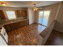 Eat-in kitchen with wood cabinets, laminate floor, and access to deck at 9120 Jene Ct, Indianapolis, IN 46234