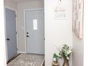 Bright entryway with gray walls, light gray door, and decorative rug at 12306 Split Granite Dr, Fishers, IN 46037