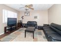 Living room with two black couches and a TV at 1704 Nelson Ave, Indianapolis, IN 46203
