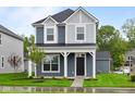 Charming two-story home with a covered front porch and well-manicured lawn at 1705 Real St, Indianapolis, IN 46240