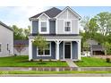 Charming two-story home with a covered front porch and well-manicured lawn at 1705 Real St, Indianapolis, IN 46240