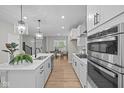 Modern kitchen featuring white cabinets, stainless steel appliances, and a spacious island at 1705 Real St, Indianapolis, IN 46240