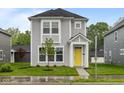 Charming two-story home with a bright yellow front door and well-manicured lawn at 1709 Real St, Indianapolis, IN 46240