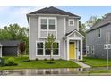 Charming two-story home with a bright yellow front door and well-manicured lawn at 1709 Real St, Indianapolis, IN 46240