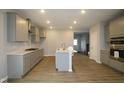 Modern kitchen with recessed lighting, stainless steel appliances, and a center island with a sink at 1709 Real St, Indianapolis, IN 46240