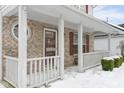 Covered front porch with brick columns, white railing and landscaping at 17802 White Willow Dr, Westfield, IN 46074